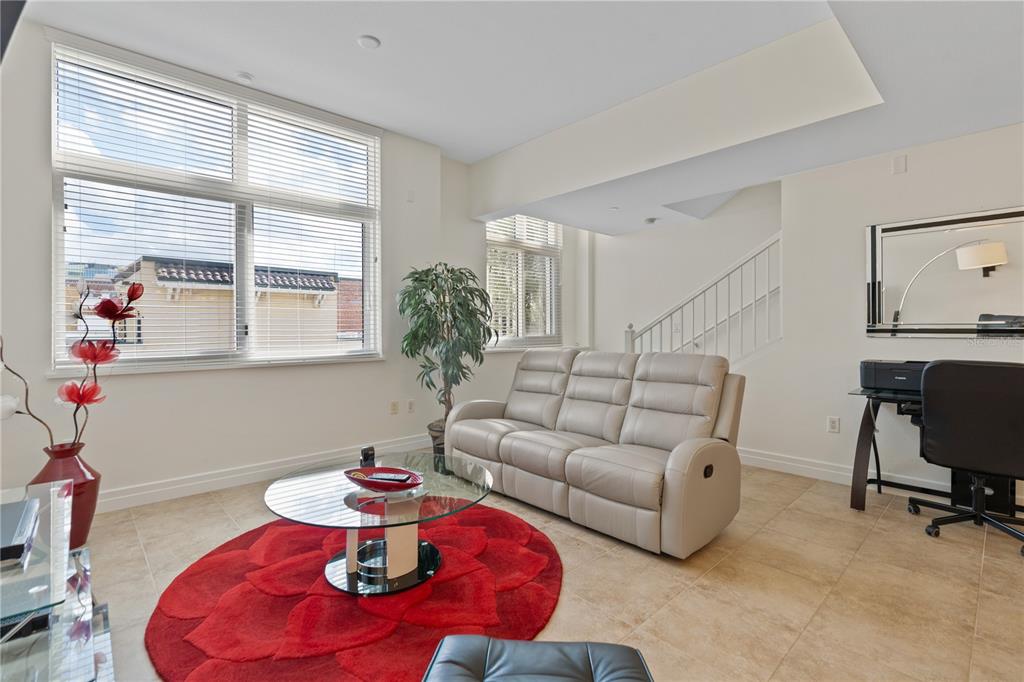 331 Cleveland Street, Unit 312 Clearwater, FL 33755 - Photo 9 of 36 a living room with furniture and a large window