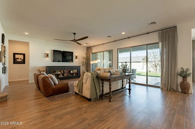 a living room with furniture and wooden floor