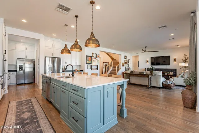 a kitchen with stainless steel appliances granite countertop a stove a microwave and a refrigerator