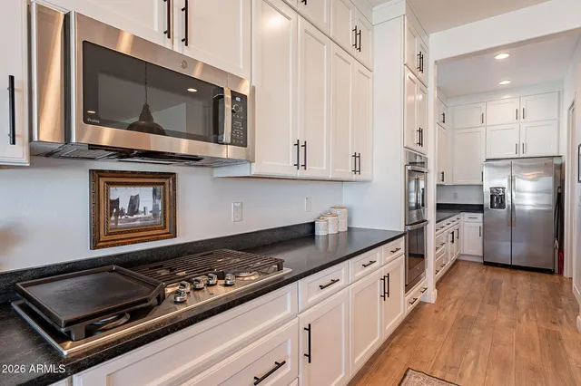 a bathroom with a granite countertop sink mirror and shower