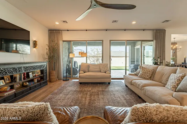 a bedroom with furniture and a flat screen tv