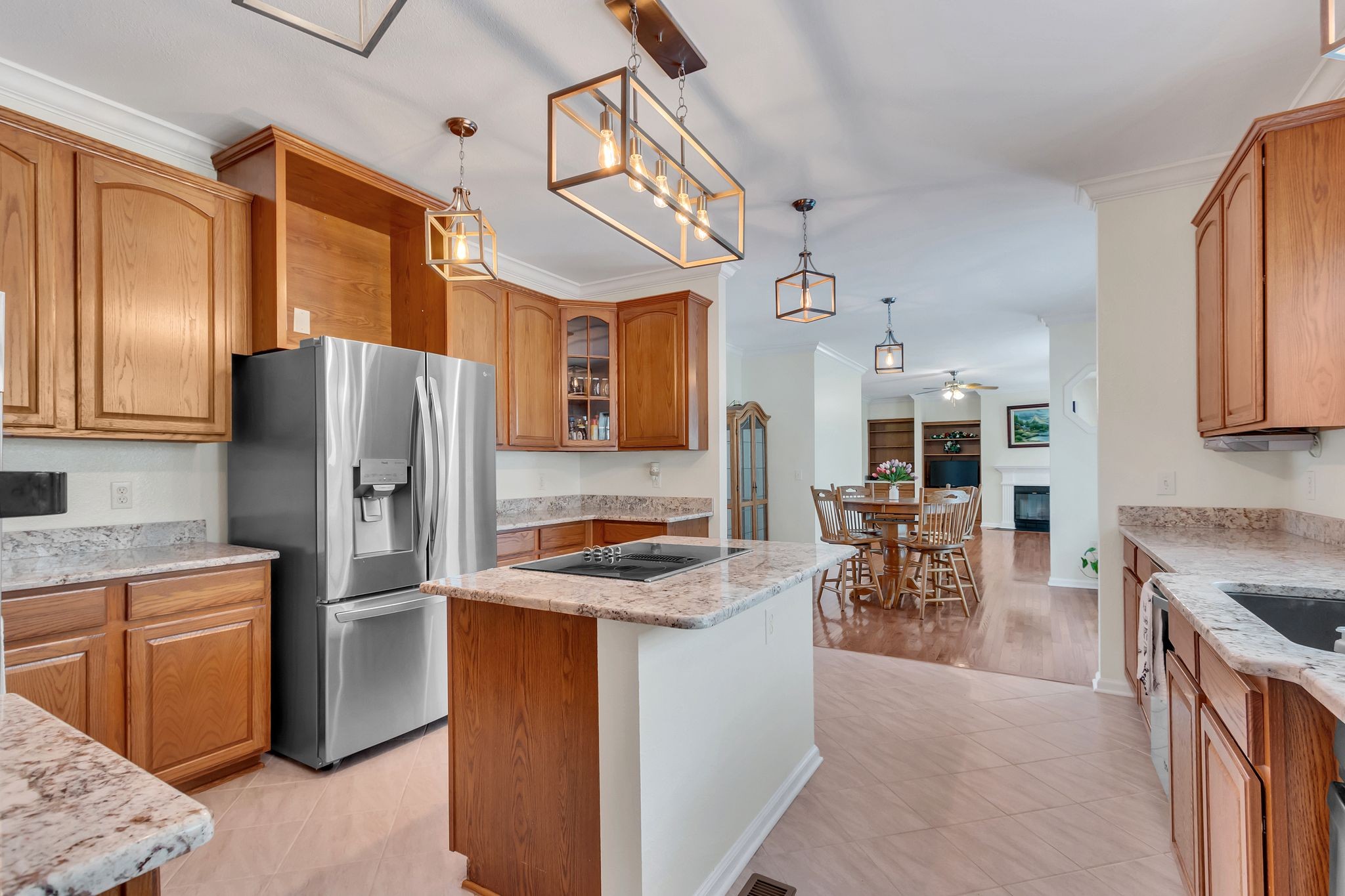 4595 Chestnut Ridge Road Columbia, TN 38401 - Photo 1 of 26 a kitchen with stainless steel appliances granite countertop a refrigerator a stove a sink a dining table and chairs with wooden floor