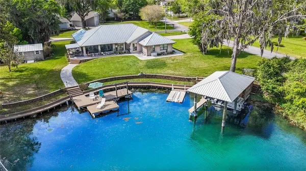 an aerial view of a house with swimming pool garden and patio
