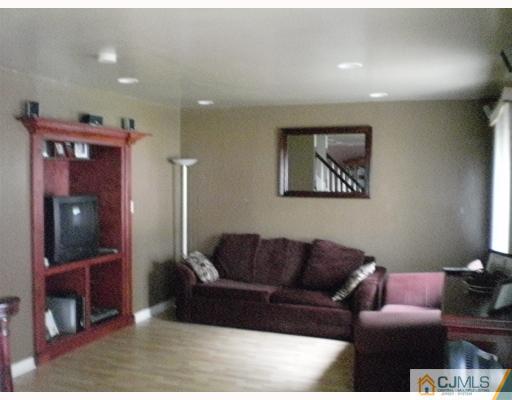10 Brookville Road Edison, NJ 08817 - Photo 4 of 11 a living room with furniture and a flat screen tv
