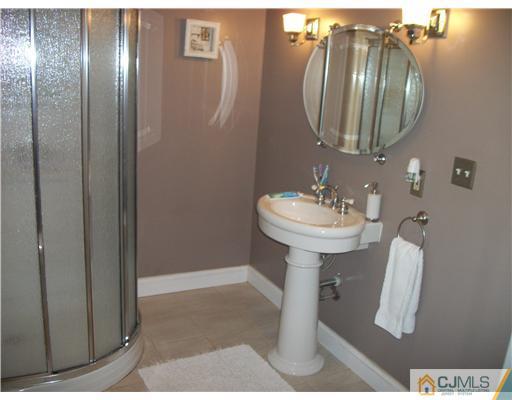 10 Brookville Road Edison, NJ 08817 - Photo 8 of 11 a bathroom with a sink and mirror