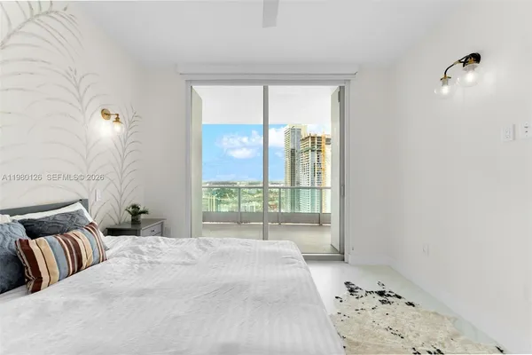 a bedroom with a large bed and a window