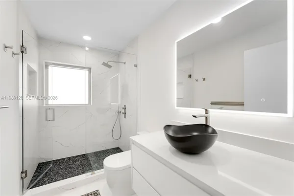 a bath room with a toilet and a bath tub