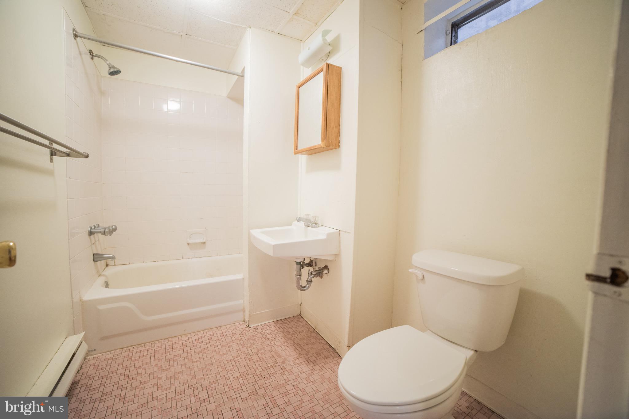 2116 Walnut Street Philadelphia, PA 19103 - Photo 10 of 12 a white toilet sitting next to a bath tub and a shower