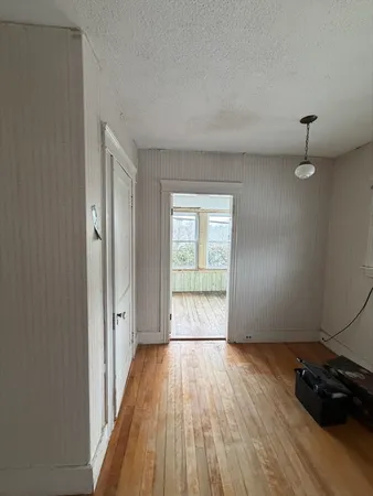 a view of an empty room and wooden floor