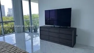 a room with furniture and large windows