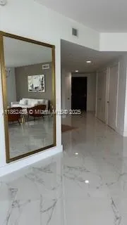 a view of a hallway with seating area