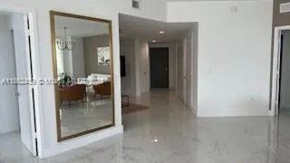 hallway with wooden floor and dining room view