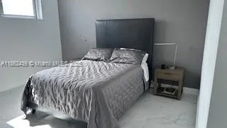 a bedroom with a bed and a chair