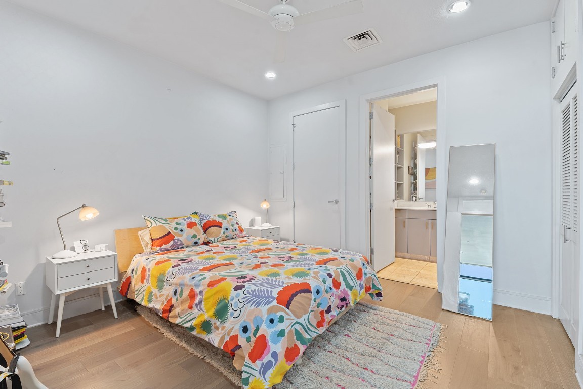 555 East 5th Street, Unit 817 Austin, TX 78701 - Photo 19 of 39 a bedroom with a bed and wooden floor