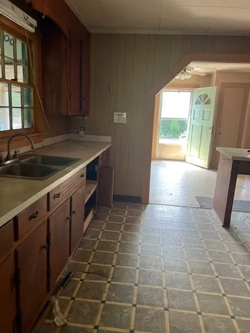 a kitchen with a sink a counter space and a window