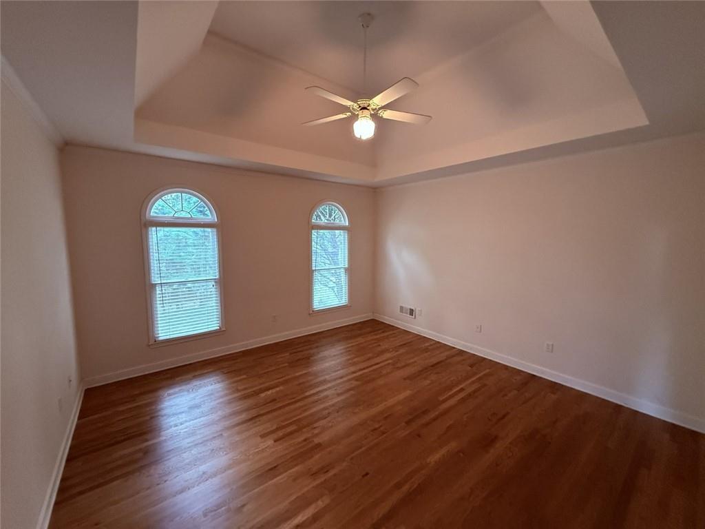 5730 Devonshire Way Cumming, GA 30040 - Photo 14 of 55 a view of empty room with wooden floor and fan