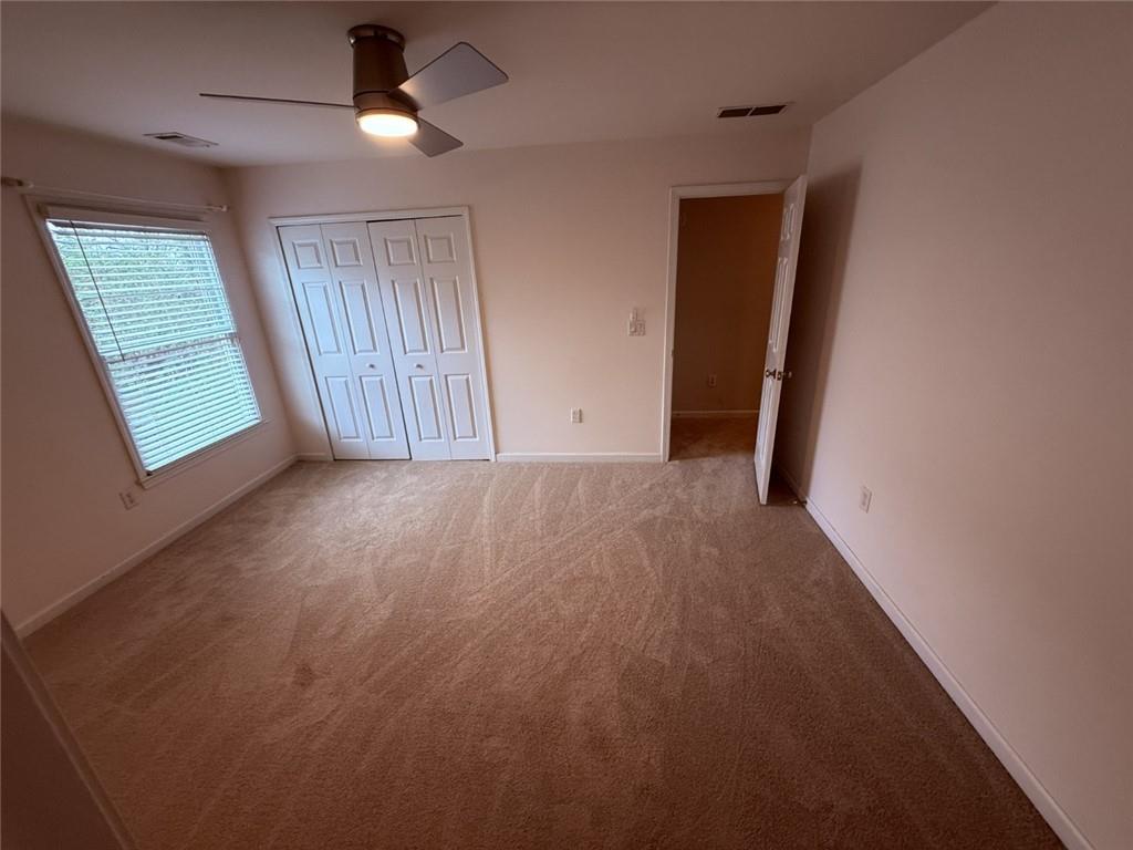 5730 Devonshire Way Cumming, GA 30040 - Photo 22 of 55 an empty room with windows and fan