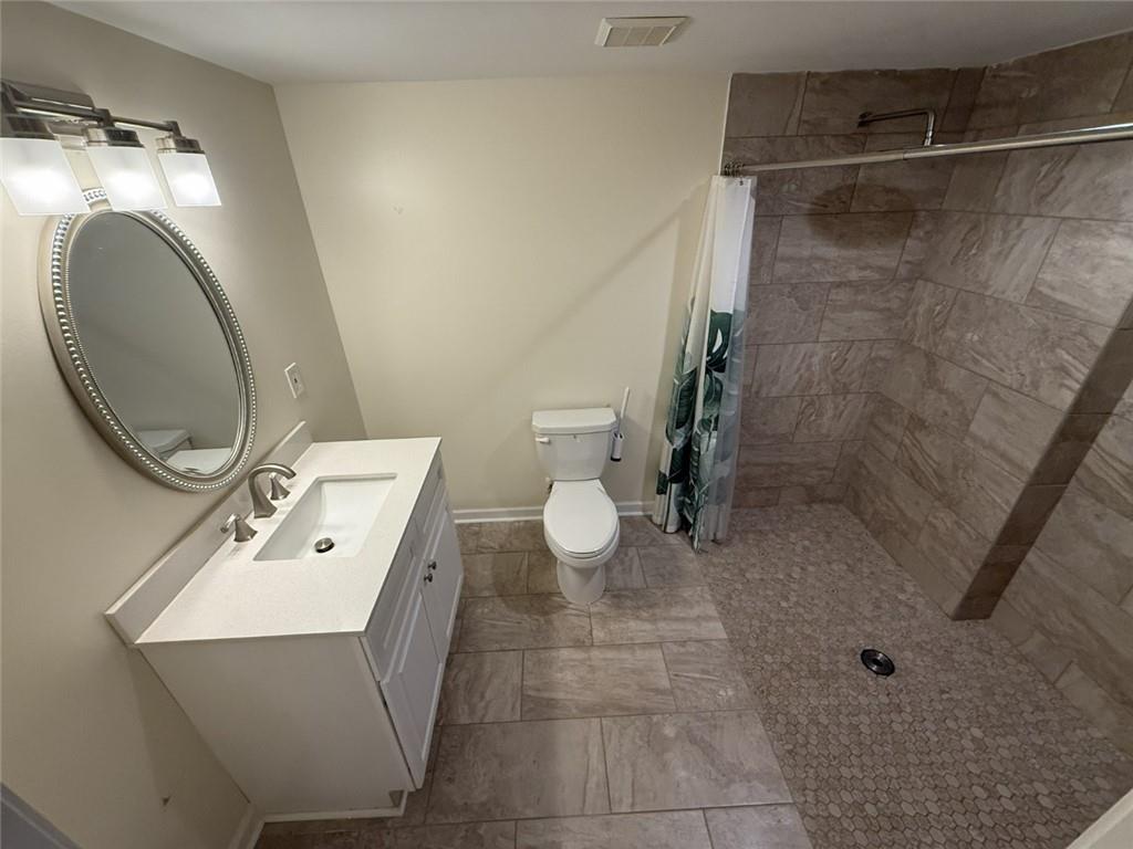 5730 Devonshire Way Cumming, GA 30040 - Photo 26 of 55 a bathroom with a sink mirror vanity and toilet