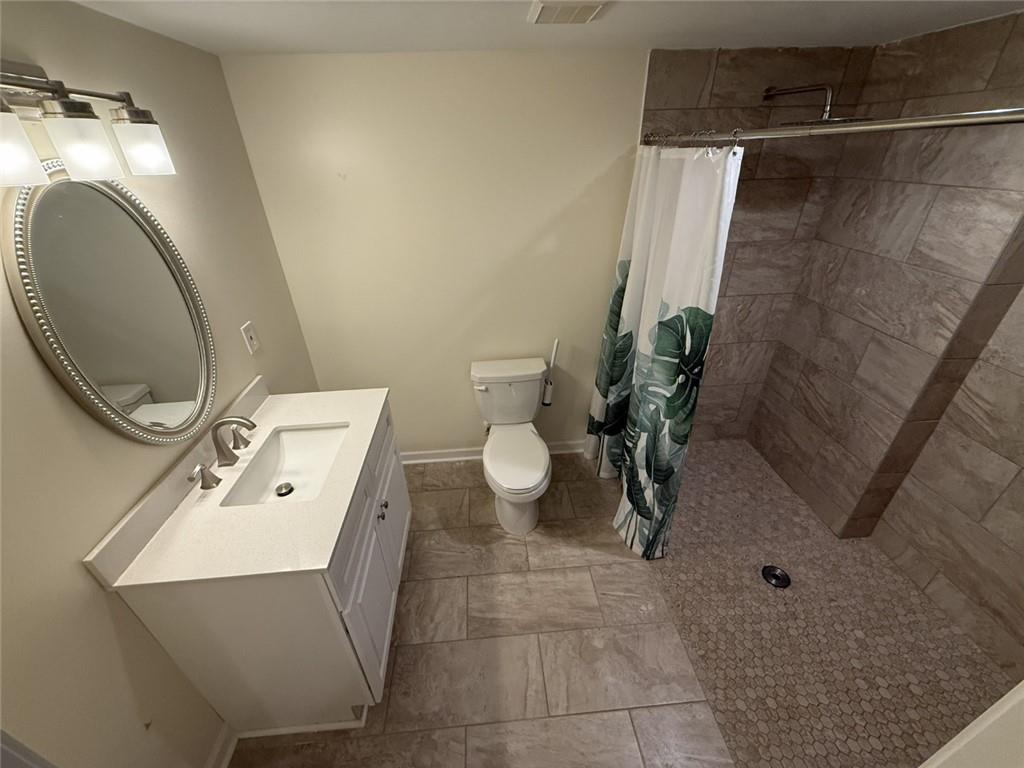 5730 Devonshire Way Cumming, GA 30040 - Photo 27 of 55 a bathroom with a toilet sink and mirror