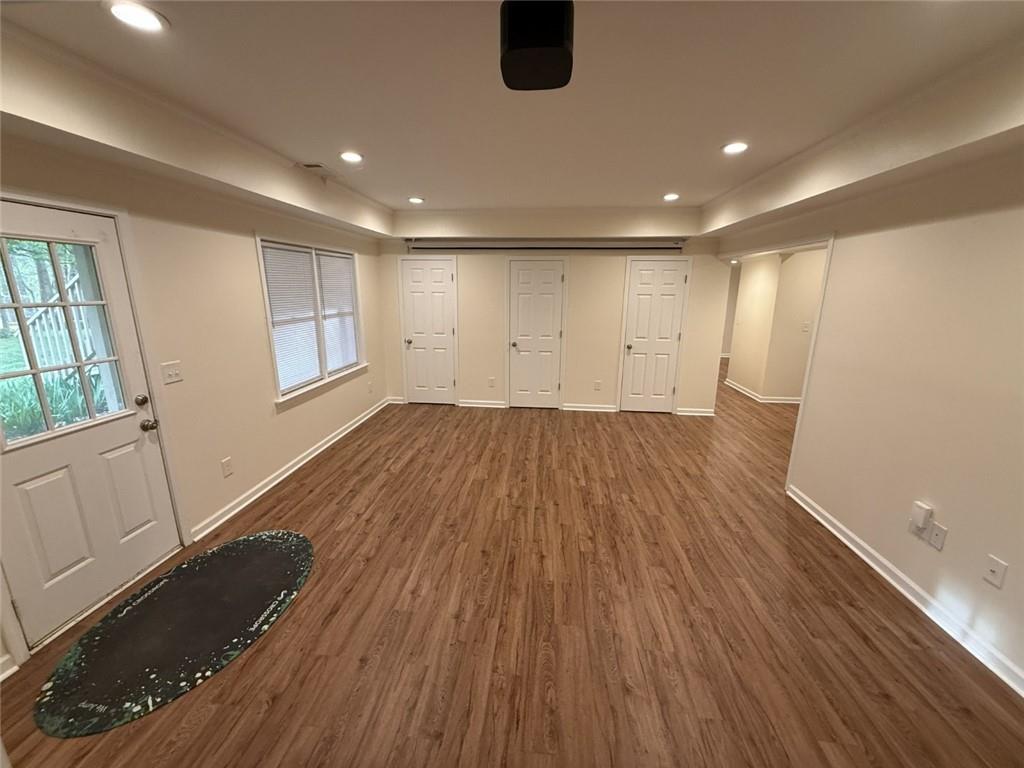 5730 Devonshire Way Cumming, GA 30040 - Photo 29 of 55 a view of an empty room with wooden floor and a window