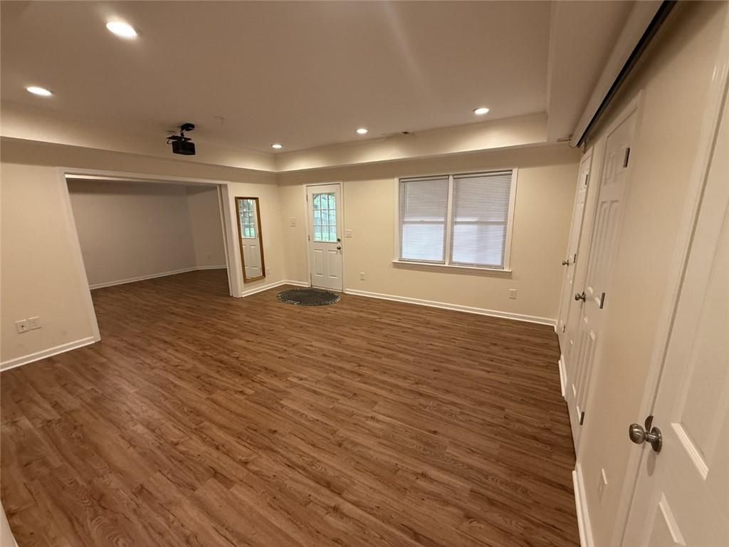 5730 Devonshire Way Cumming, GA 30040 - Photo 30 of 55 an empty room with wooden floor and windows