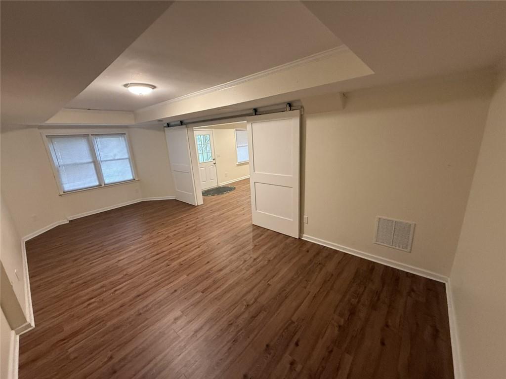 5730 Devonshire Way Cumming, GA 30040 - Photo 35 of 55 an empty room with wooden floor and windows
