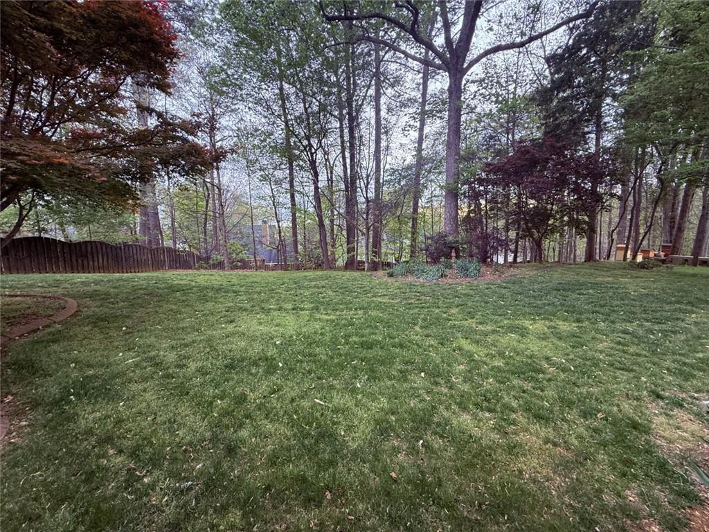 5730 Devonshire Way Cumming, GA 30040 - Photo 42 of 55 a big yard with lots of green space and trees