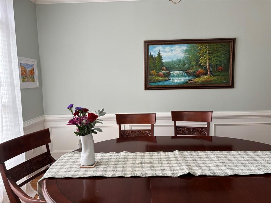 5730 Devonshire Way Cumming, GA 30040 - Photo 54 of 55 a view of a dining room with furniture and wooden floor