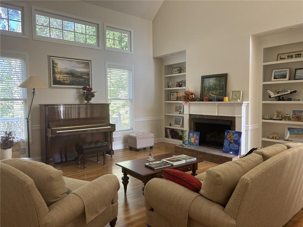 5730 Devonshire Way Cumming, GA 30040 - Photo 55 of 55 a living room with furniture a flat screen tv and a fireplace