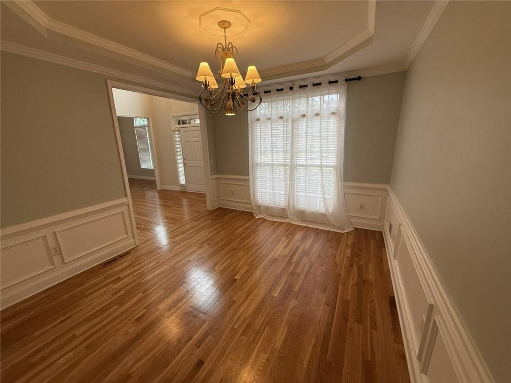 5730 Devonshire Way Cumming, GA 30040 - Photo 8 of 55 wooden floor in an empty room with a window