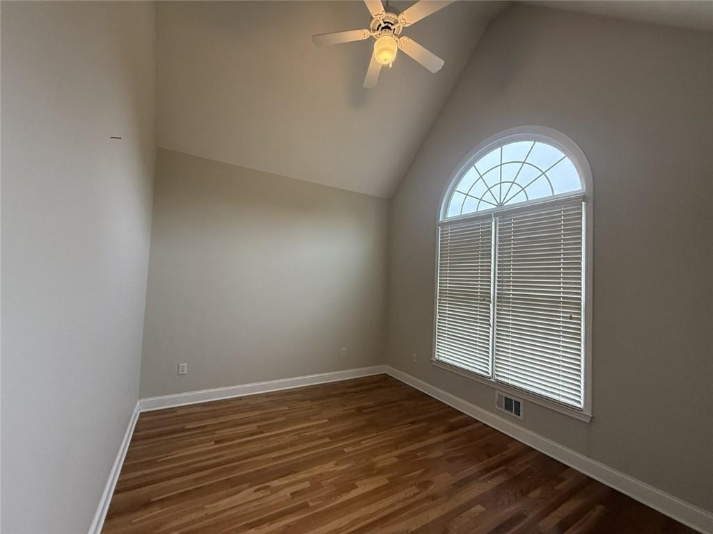 5730 Devonshire Way Cumming, GA 30040 - Photo 9 of 55 an empty room with wooden floor fan and windows