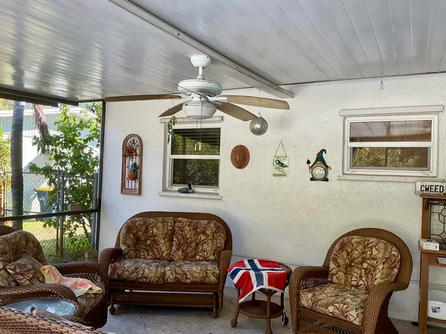 a view of a patio with table and chairs and potted plants