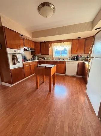 a kitchen with stainless steel appliances granite countertop a refrigerator and a sink