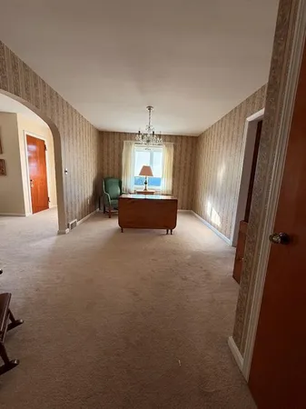 a view of a livingroom with furniture and a ceiling fan