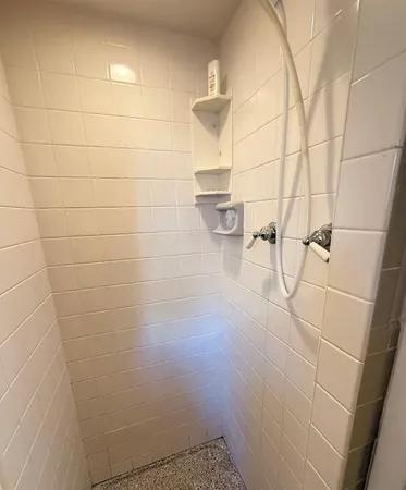 a bathroom with a toilet and a shower