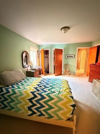 a bedroom with furniture and a window