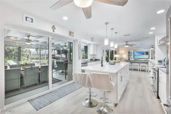 a view of a kitchen and dining area with chandelier