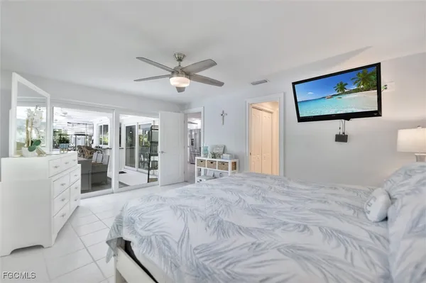 a large bedroom with a large bed and a flat screen tv