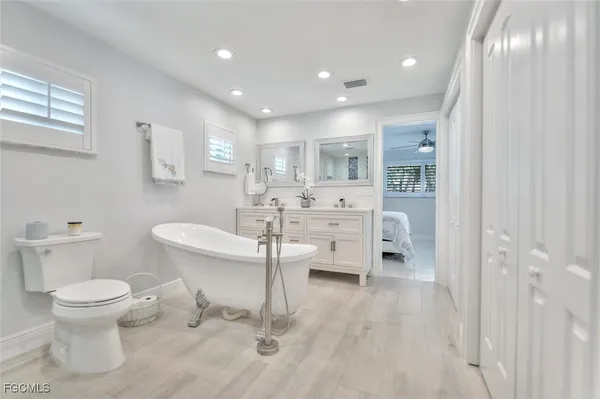 a bathroom with a toilet sink and a mirror