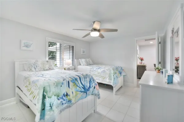 a bedroom with bed and a chandelier
