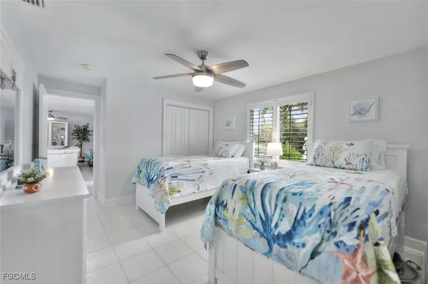 a bedroom with two beds and a chandelier