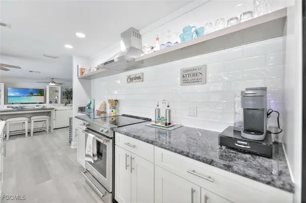 a kitchen with a sink a stove and cabinets