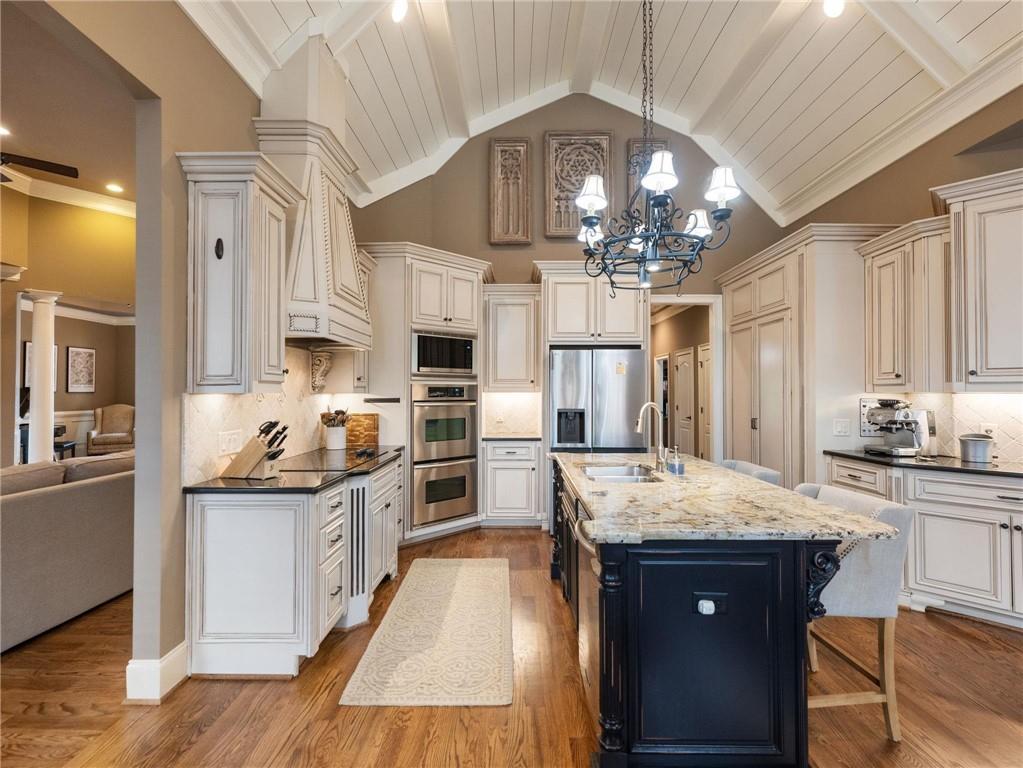 6147 Golf View Court Jefferson, GA 30549 - Photo 13 of 73 a kitchen with stainless steel appliances granite countertop a sink stove and refrigerator