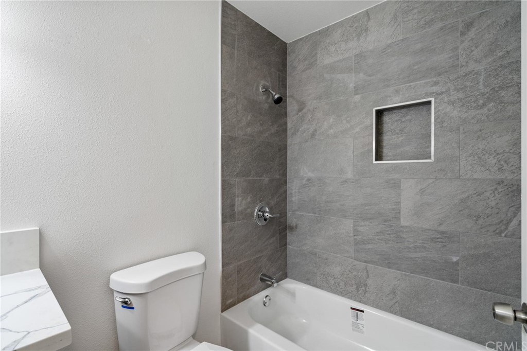 19309 Belshaw Avenue Carson, CA 90746 - Photo 16 of 40 a bathroom with a bathtub and toilet