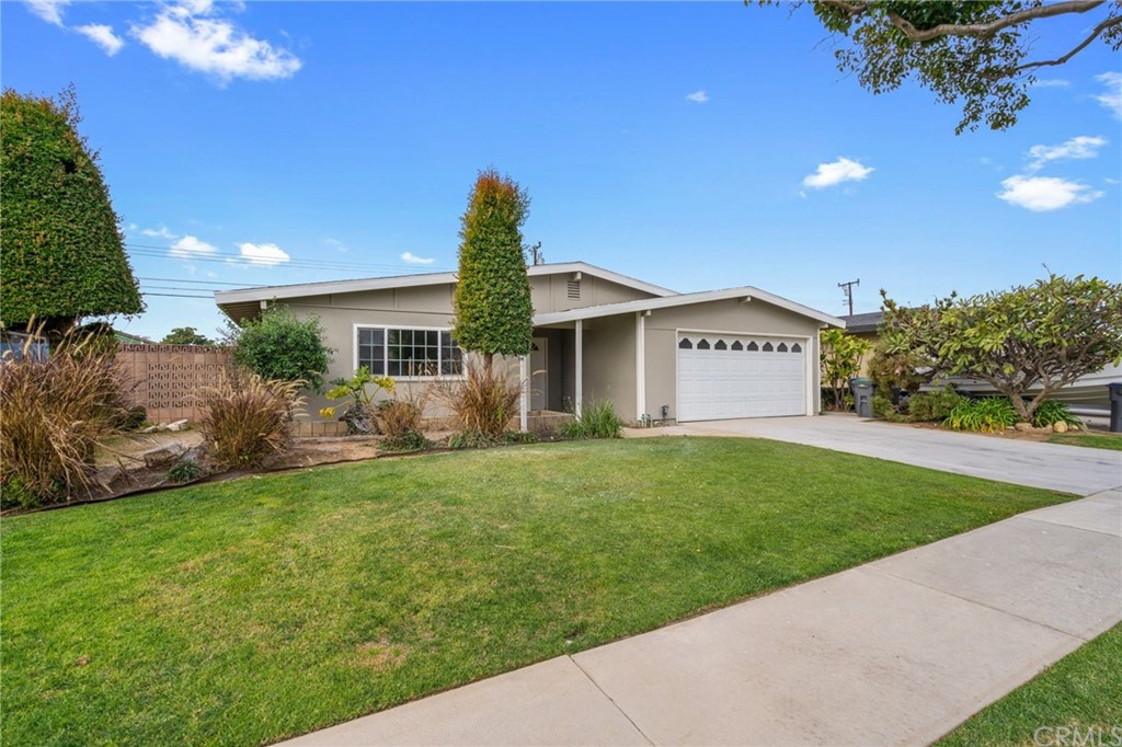 19309 Belshaw Avenue Carson, CA 90746 - Photo 2 of 40 a front view of a house with a yard and garage