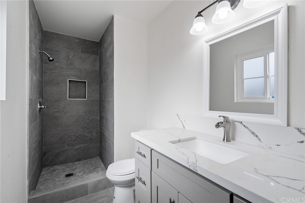 19309 Belshaw Avenue Carson, CA 90746 - Photo 21 of 40 a bathroom with a sink a toilet and shower