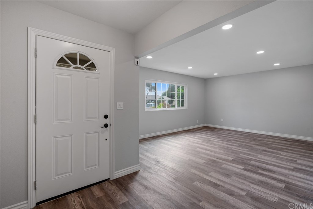 19309 Belshaw Avenue Carson, CA 90746 - Photo 5 of 40 an empty room with wooden floor and windows