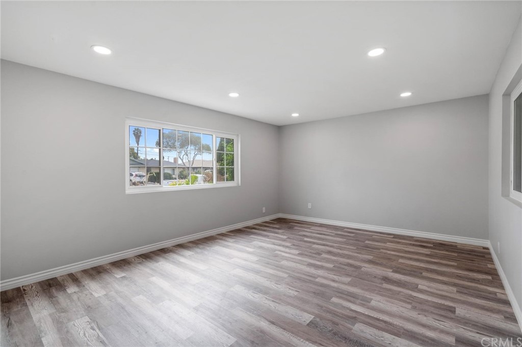 19309 Belshaw Avenue Carson, CA 90746 - Photo 6 of 40 a view of an empty room with wooden floor and a window