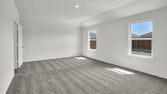 an empty room with a empty space and windows