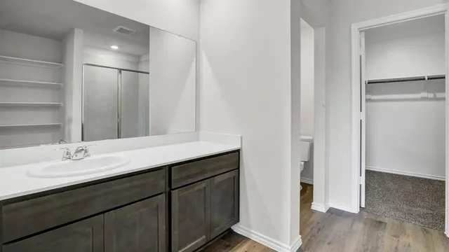 a bathroom with a double vanity sink a mirror and shower